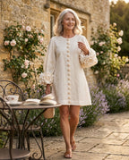 Softly draped shift dress with sculptural rosette cuffs